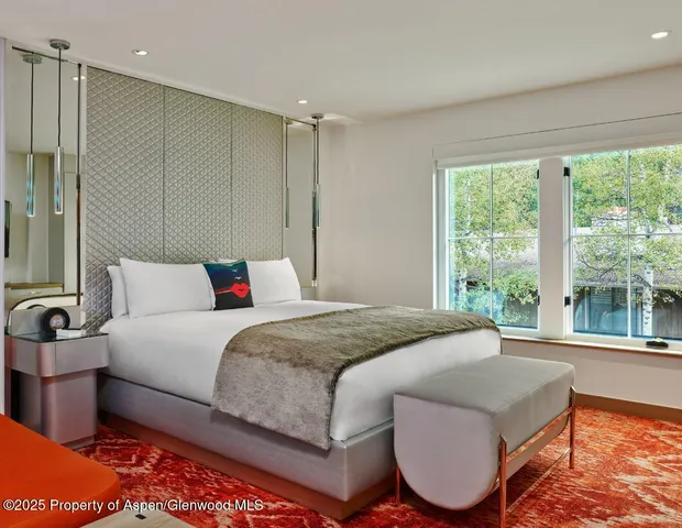 a bedroom with a large bed and a large window