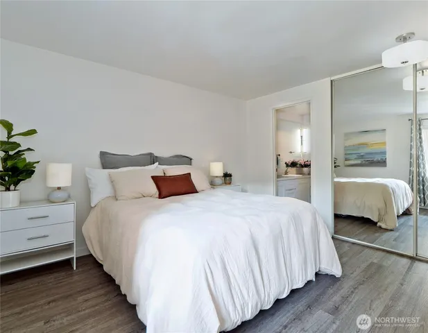 a bedroom with bed and a closet