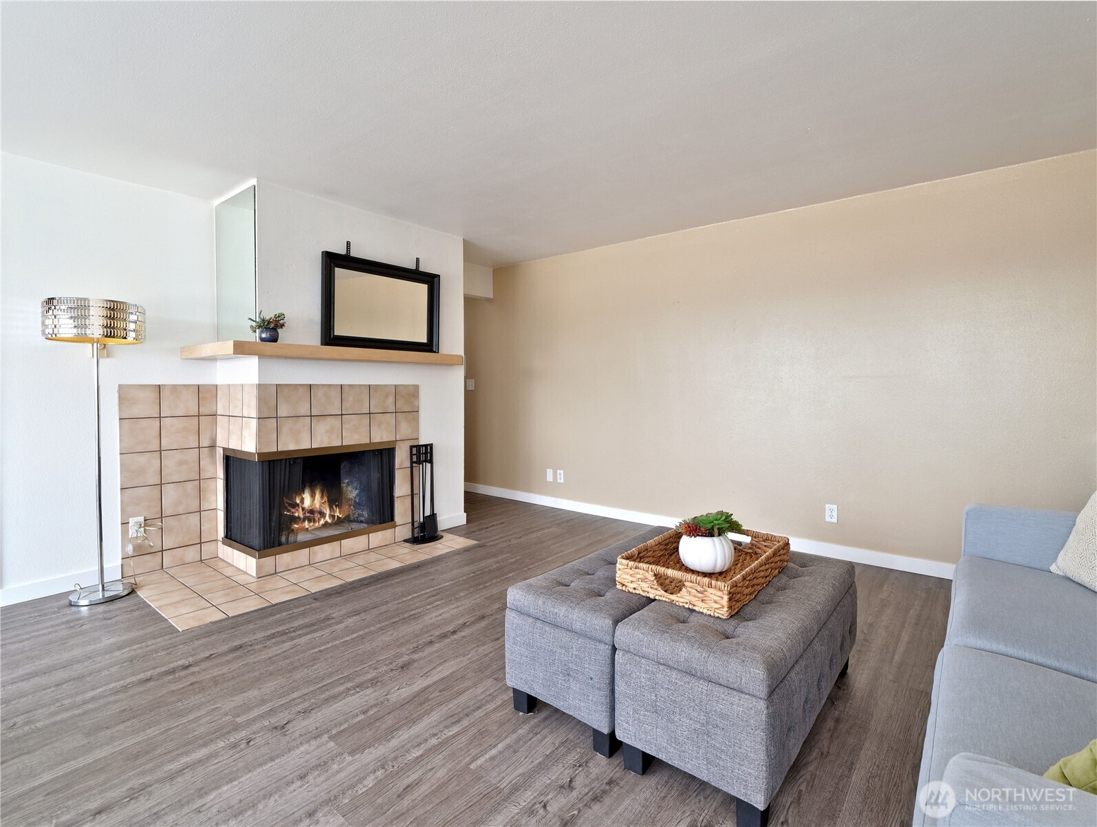3700 25th Place West, Unit 202 Seattle, WA 98199 - Photo 5 of 21 a living room with furniture and a fireplace
