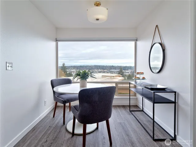 a view of a dining room with furniture window and wooden floor