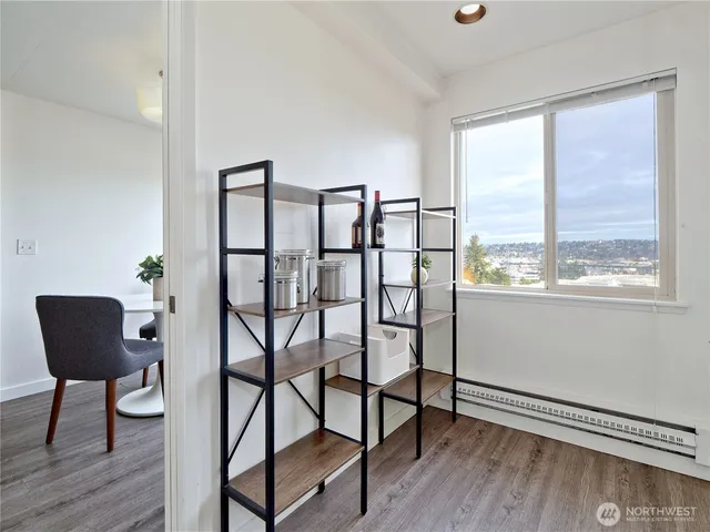 a view of a workspace room with furniture and wooden floor
