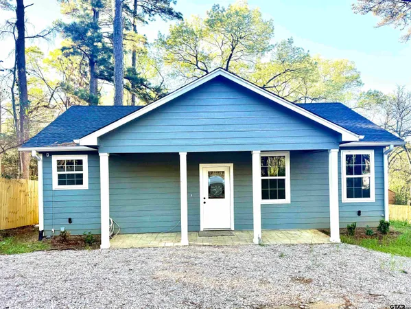 a large kitchen with stainless steel appliances kitchen island granite countertop a refrigerator and a stove top oven