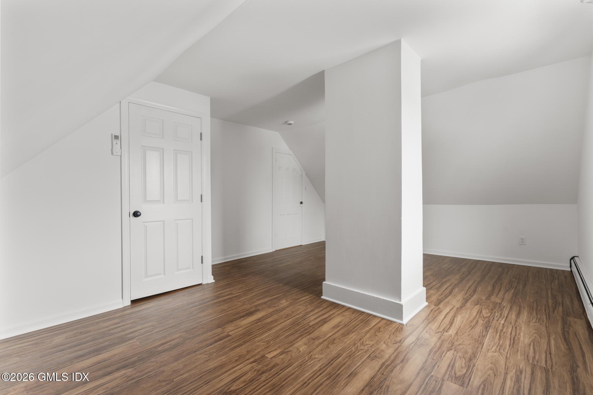 134 River Rd Extension, Unit 2 Cos Cob, CT 06807 - Photo 17 of 19 an empty room with wooden floor