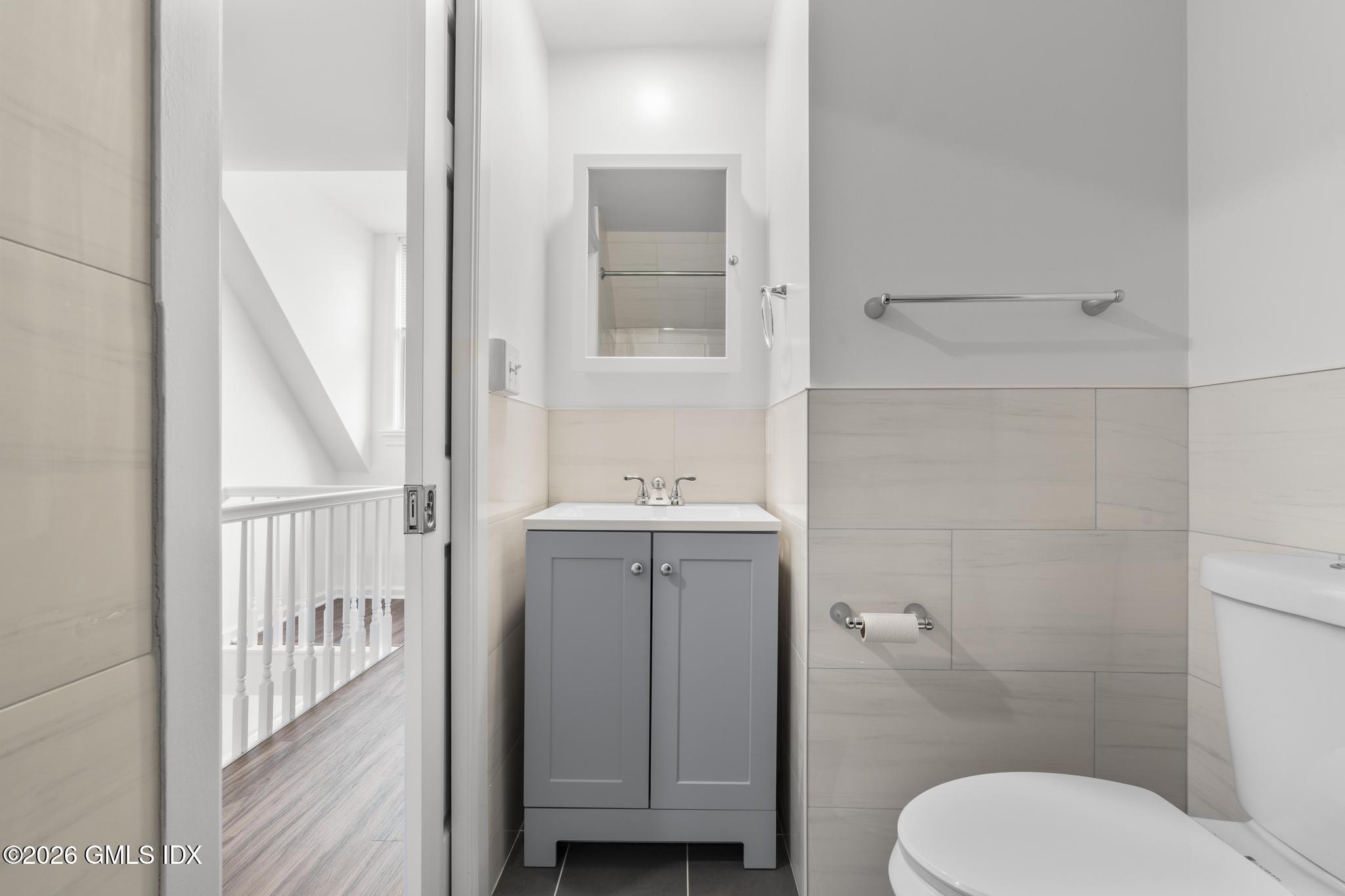 134 River Rd Extension, Unit 2 Cos Cob, CT 06807 - Photo 19 of 19 a bathroom with a toilet a sink and mirror