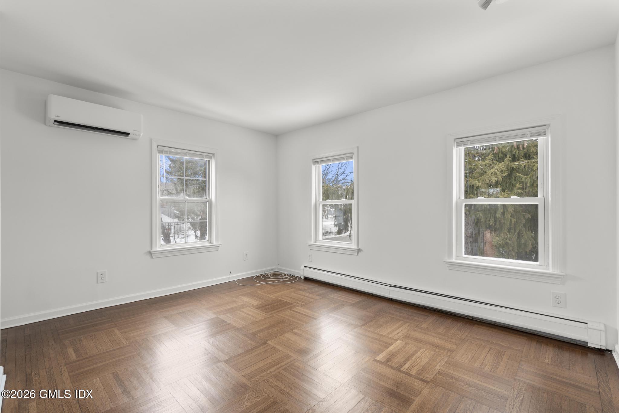 134 River Rd Extension, Unit 2 Cos Cob, CT 06807 - Photo 3 of 19 a view of an empty room with a window and wooden floor
