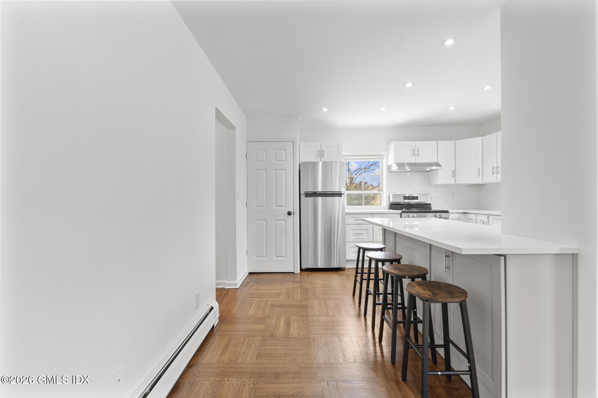 134 River Rd Extension, Unit 2 Cos Cob, CT 06807 - Photo 4 of 19 a kitchen with stainless steel appliances granite countertop a refrigerator and a stove top oven