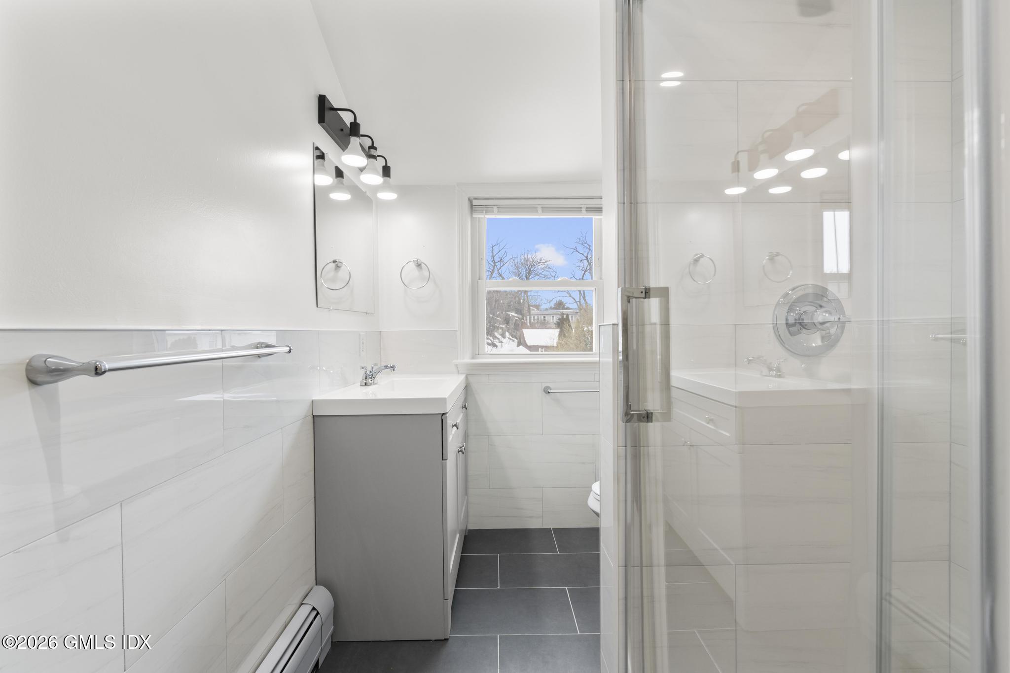 134 River Rd Extension, Unit 2 Cos Cob, CT 06807 - Photo 6 of 19 a bathroom with a sink a mirror and shower