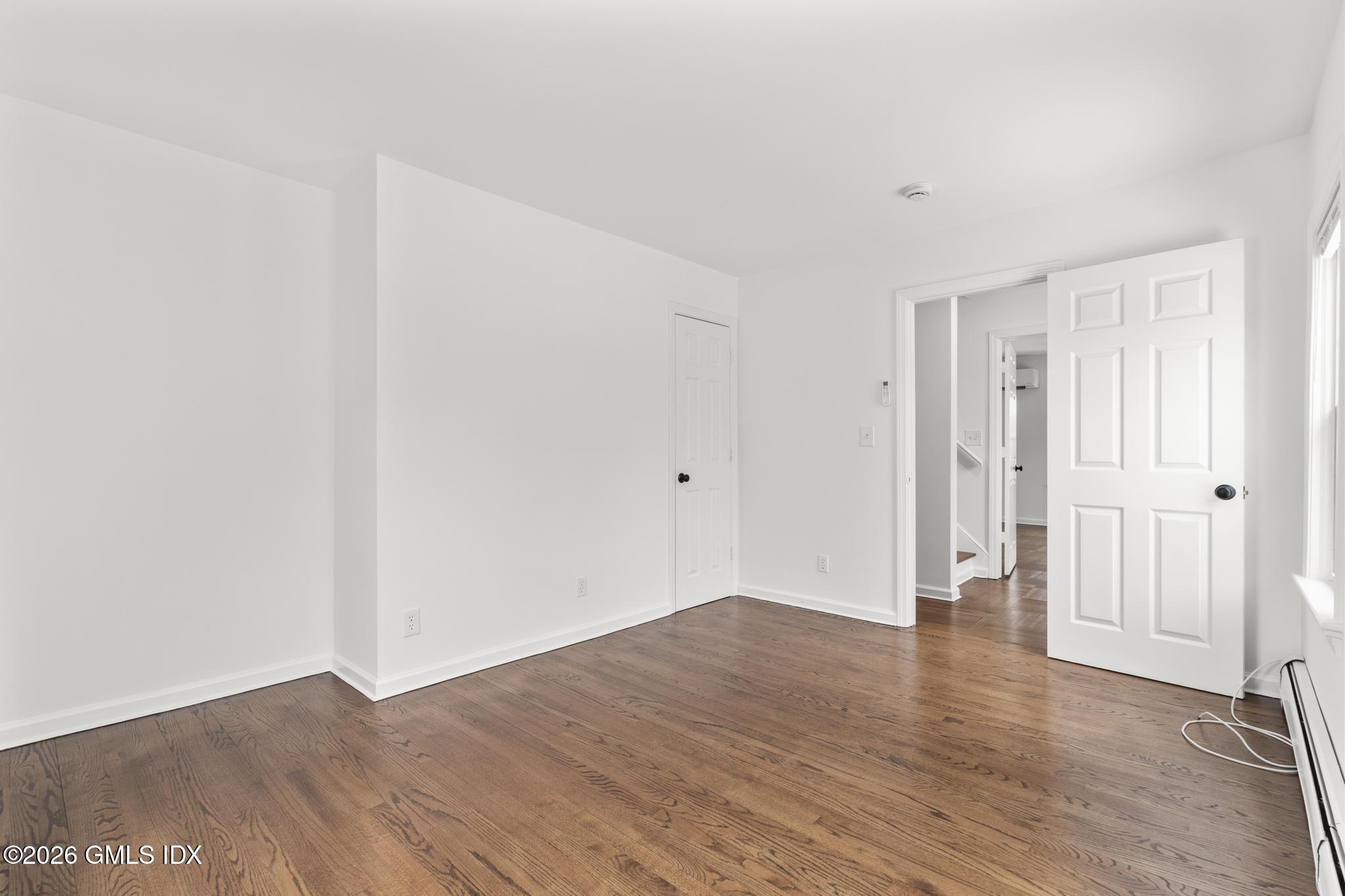 134 River Rd Extension, Unit 2 Cos Cob, CT 06807 - Photo 10 of 19 a view of an empty room with wooden floor