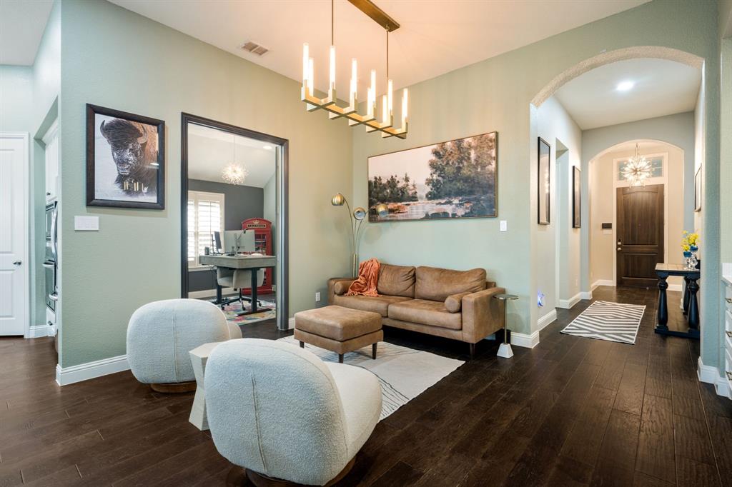 1501 Snowdrop Drive Prosper, TX 75078 - Photo 13 of 27 a living room with furniture and a chandelier