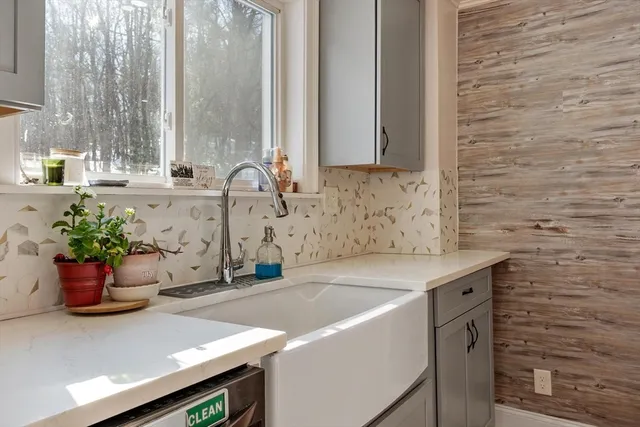 a kitchen with stainless steel appliances kitchen island granite countertop a refrigerator a stove a microwave oven a sink with island and chairs