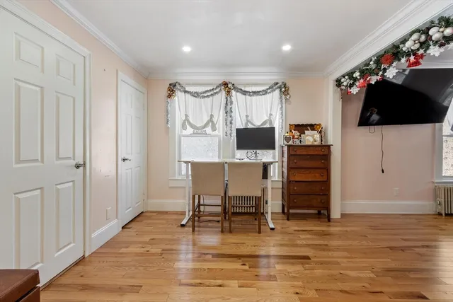 a view of a livingroom with furniture window and wooden floor