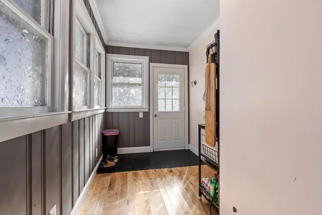 a view of a hallway with wooden floor and staircase