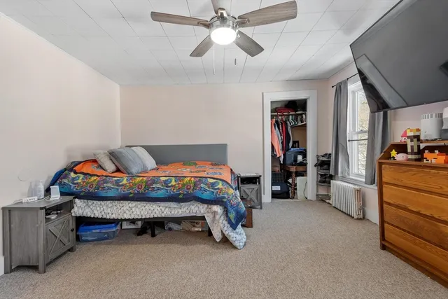 a room with a bed and a chandelier