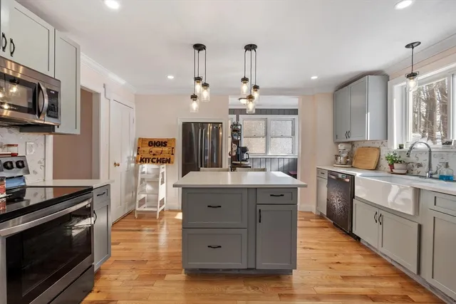 a kitchen with a refrigerator and a sink