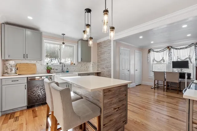 a kitchen with a table chairs refrigerator and cabinets