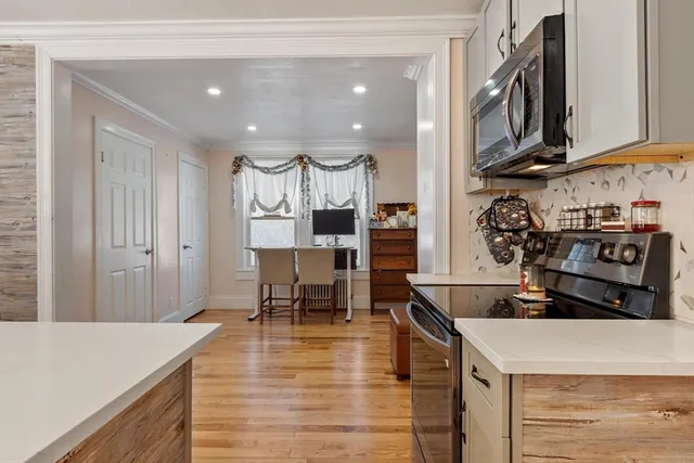 a kitchen with a sink window and cabinets