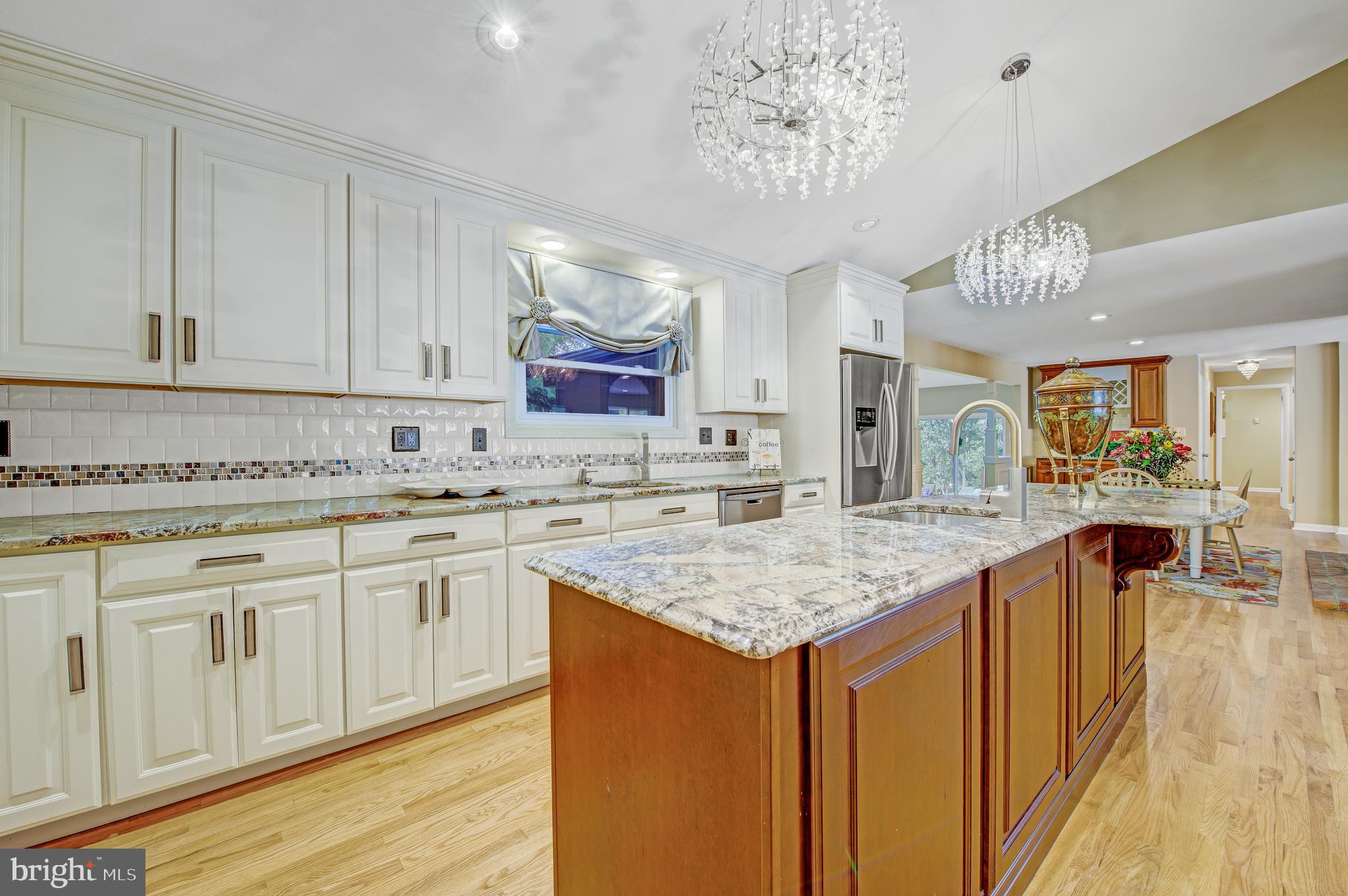 a kitchen with stainless steel appliances granite countertop a sink dishwasher and cabinets with wooden floor
