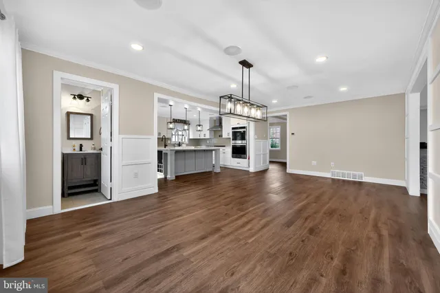 a view of a kitchen with a sink and dishwasher wooden floor kitchen view