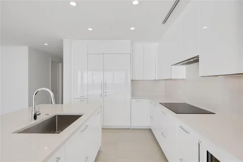 a kitchen with a sink and white cabinets