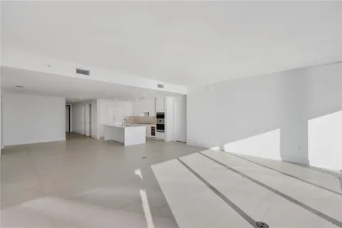 a large white bed in a white room