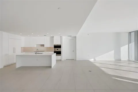 a view of kitchen with white cabinets and stainless steel appliances