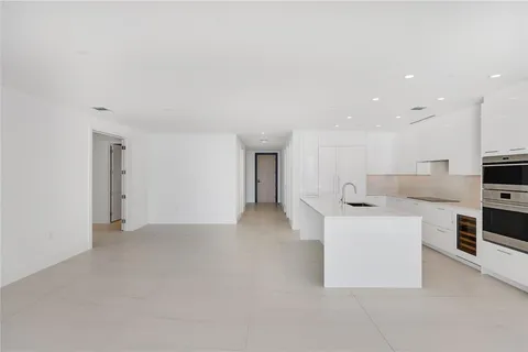 a kitchen with stainless steel appliances kitchen island sink refrigerator and stove