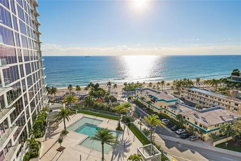 an aerial view of residential building and ocean view