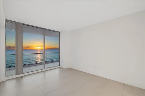 an empty room with sliding glass door