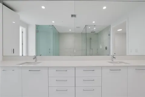 a spacious bathroom with a bathtub and shower