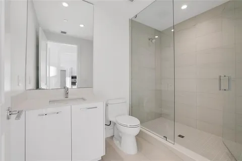a bathroom with a shower and a glass door