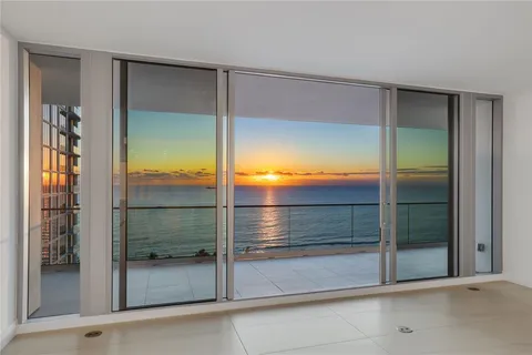 a bathroom with a glass shower door and a mirror