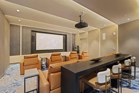 a living room with furniture a flat screen tv and a large window