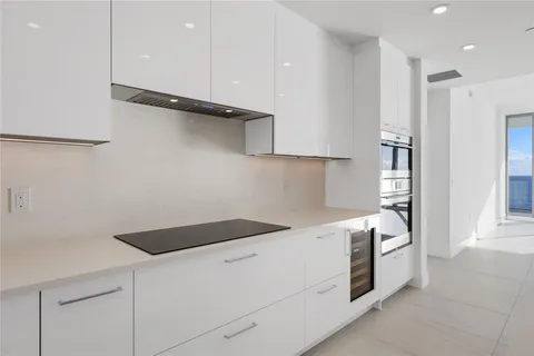 a kitchen with a stove and a refrigerator