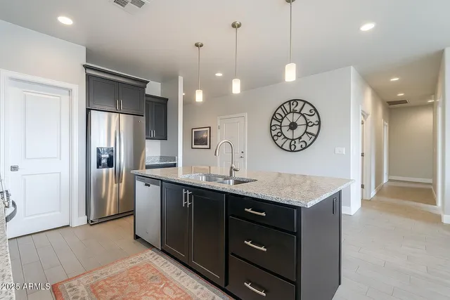 a kitchen with a refrigerator a sink and a refrigerator