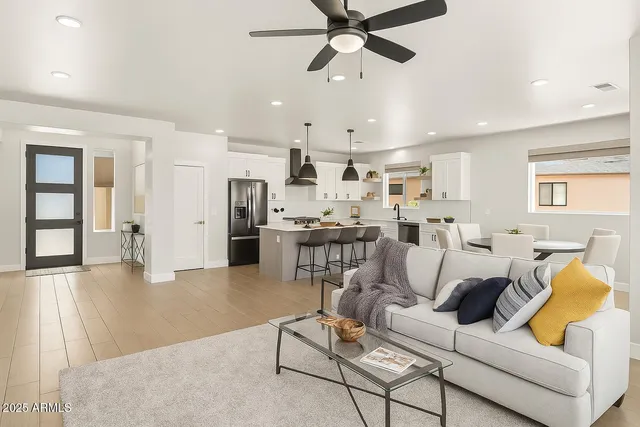 a living room with lots of furniture and kitchen view
