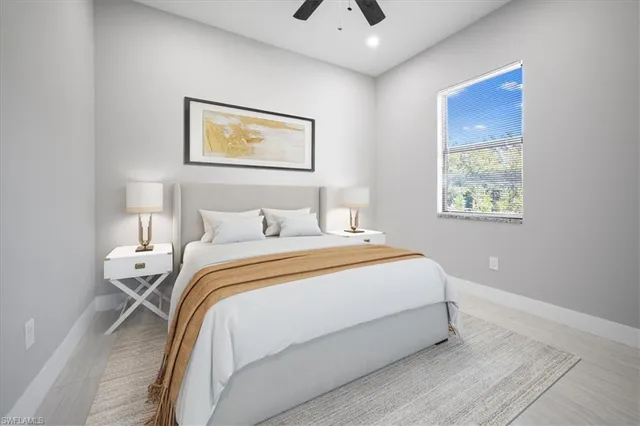 a bedroom with a bed and a painting on the wall