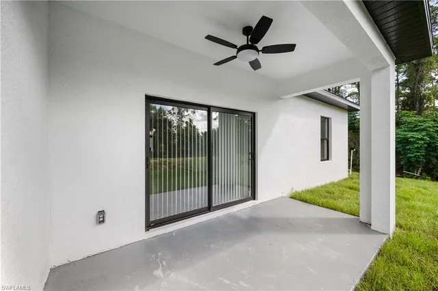 a view of a livingroom with a ceiling fan and wooden floor