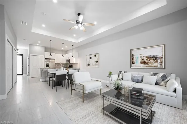 a living room with furniture and kitchen view