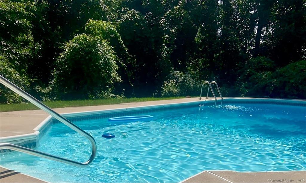 a view of a pool with a yard