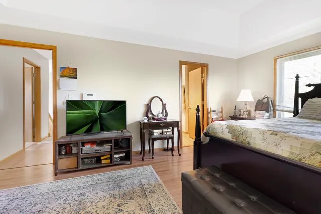 a bedroom with furniture and a flat screen tv