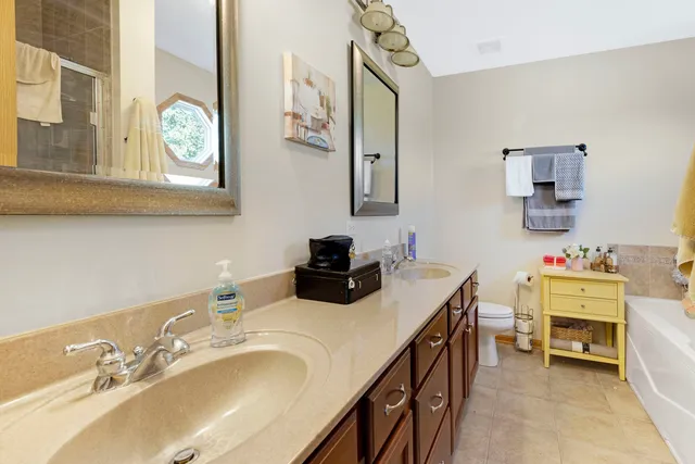 a bathroom with a double vanity sink and a mirror