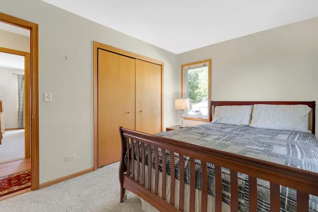 a bed sitting in a bedroom next to a window