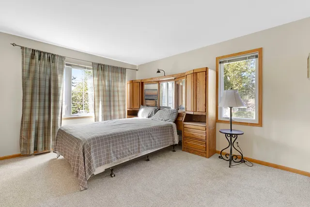 a bedroom with a large bed and a dresser