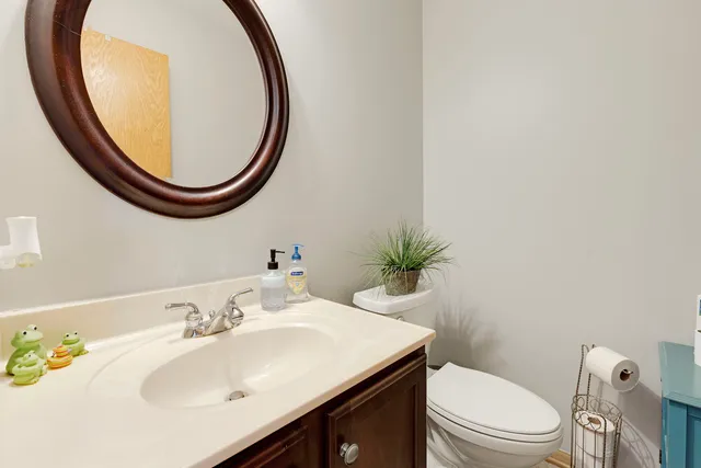 a bathroom with a sink a toilet and a mirror