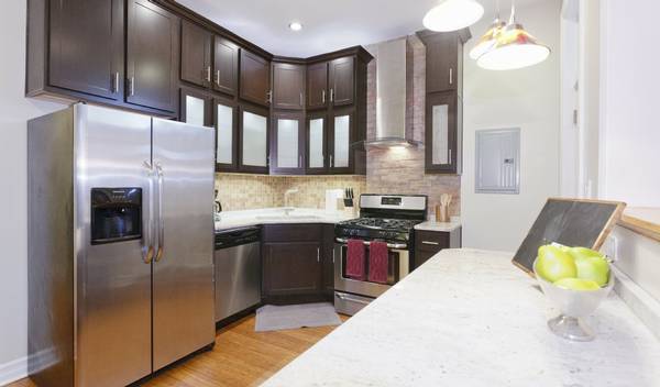 3529 North Reta Avenue, Unit 3R Chicago, IL 60657 - Photo 2 of 14 a kitchen with cabinets and stainless steel appliances
