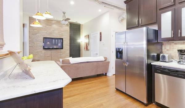 3529 North Reta Avenue, Unit 3R Chicago, IL 60657 - Photo 4 of 14 a large kitchen with stainless steel appliances granite countertop a refrigerator a oven and a sink with large cabinets