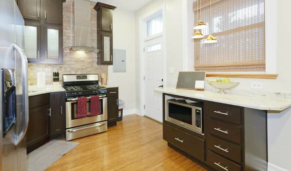 3529 North Reta Avenue, Unit 3R Chicago, IL 60657 - Photo 5 of 14 a kitchen with stainless steel appliances granite countertop a stove a sink and a refrigerator