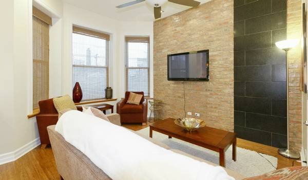 3529 North Reta Avenue, Unit 3R Chicago, IL 60657 - Photo 6 of 14 a living room with furniture a rug and a window