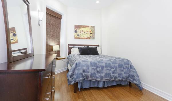 3529 North Reta Avenue, Unit 3R Chicago, IL 60657 - Photo 10 of 14 a bedroom with a bed and wooden floor