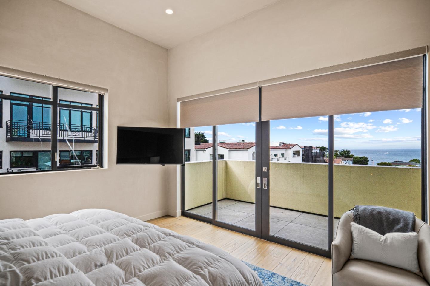 520 Lighthouse Avenue, Unit 301 Pacific Grove, CA 93950 - Photo 15 of 23 a bedroom with a bed and a flat screen tv